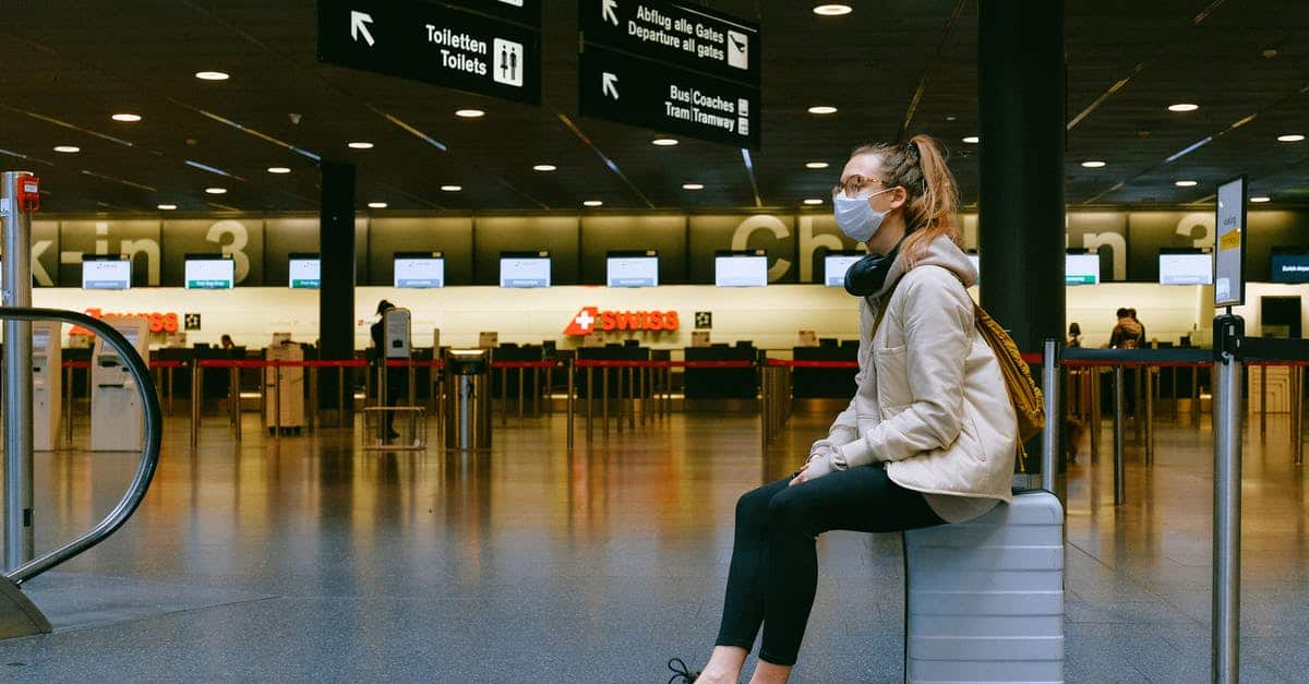 A man and a woman waiting at the airport