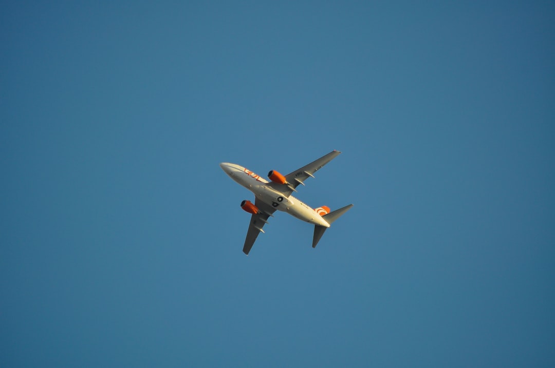 A large passenger jet flying through a clear blue sky