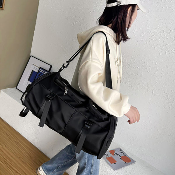A woman holding a piece of luggage
